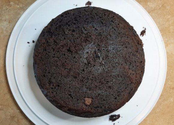 round chocolate cake on a white platter