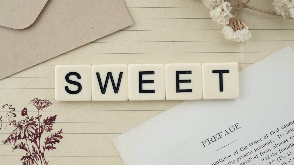 scrabble letters that spell sweet on a desk