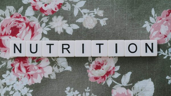 letters spelling out nutrition on flowery background